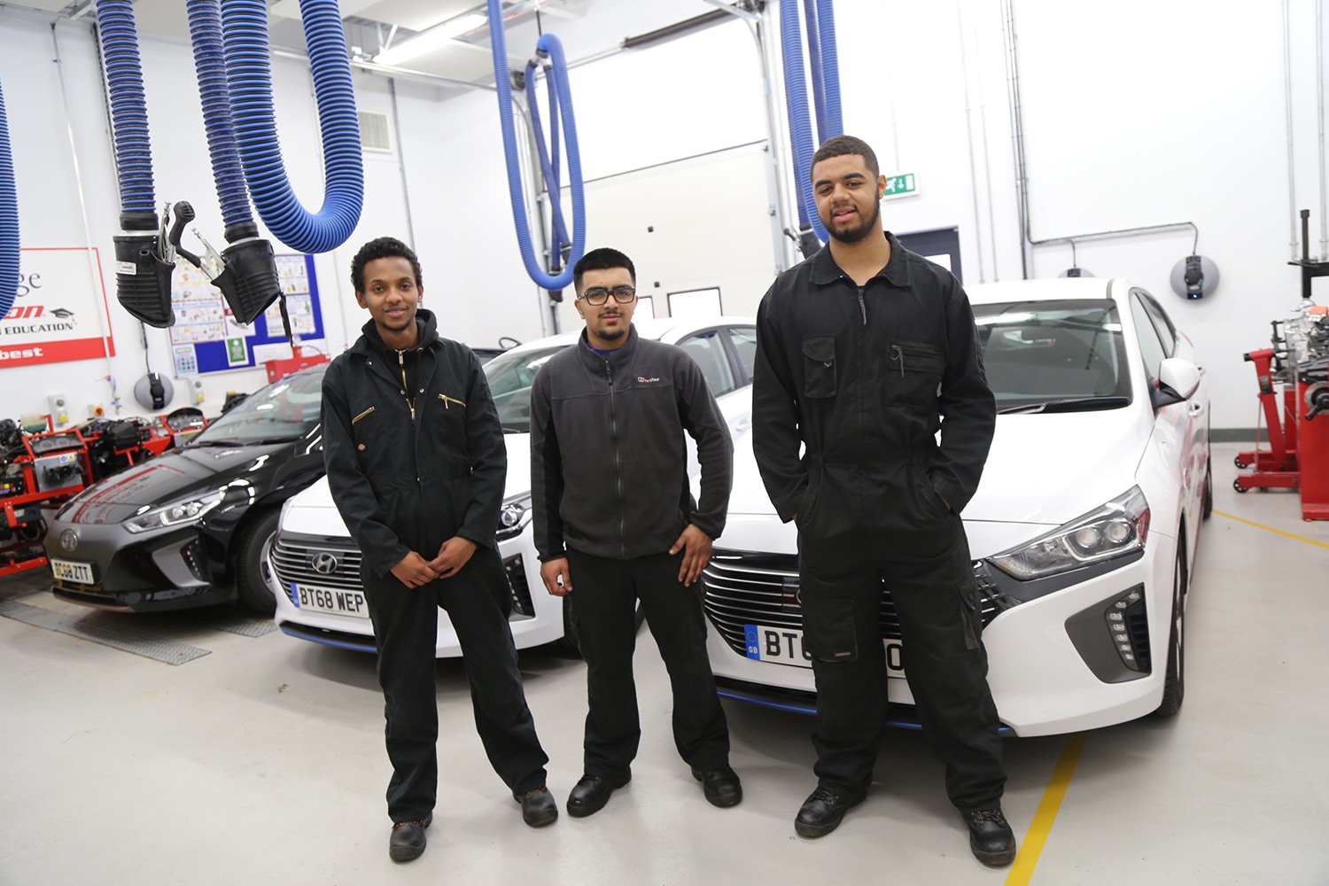 Motor Vehicle students in front of new hybrid vehicles