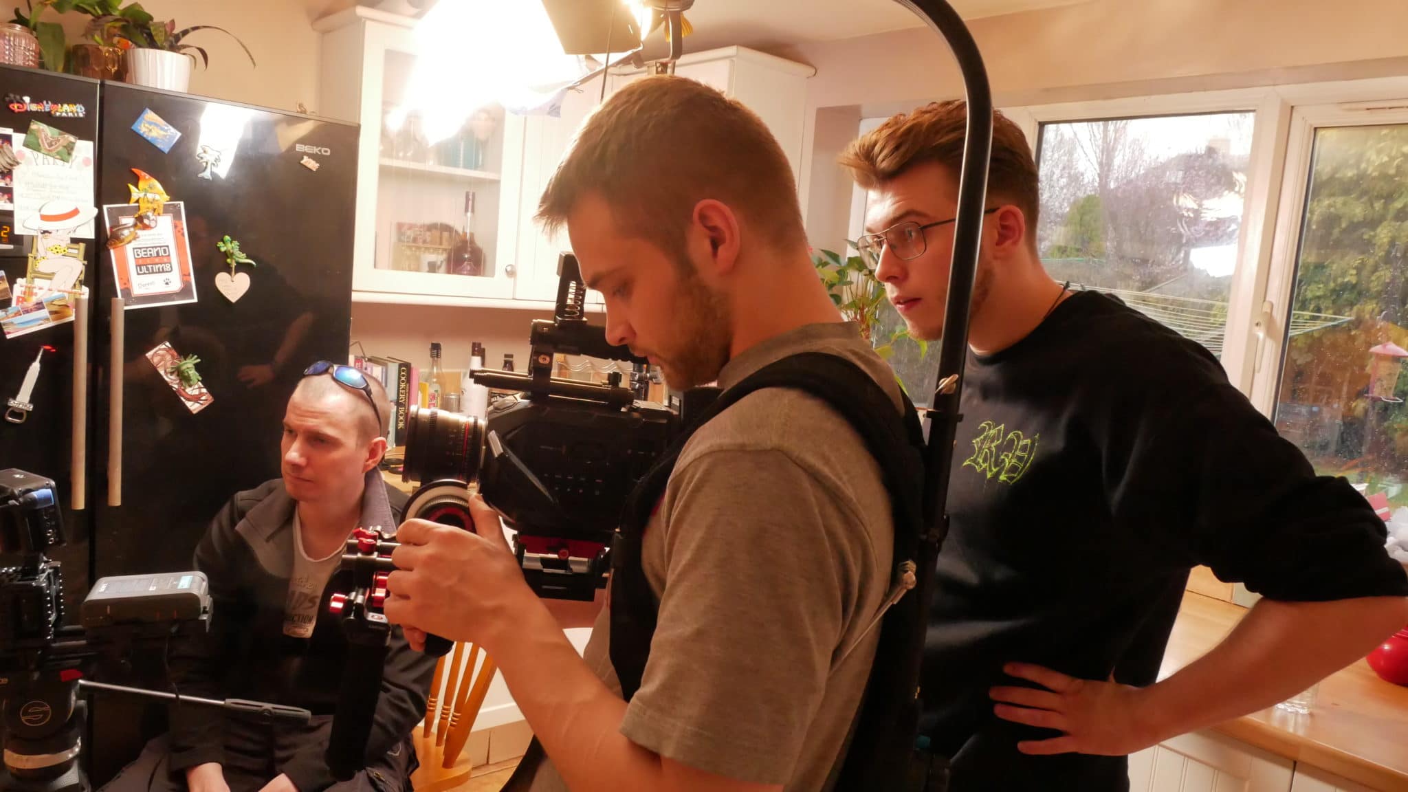 Daniel in the kitchen with a camera man filming