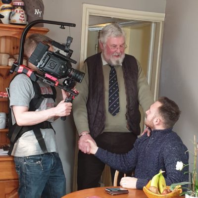 Student filming two people for documentary