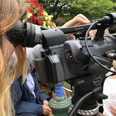 A student looking through a video camera