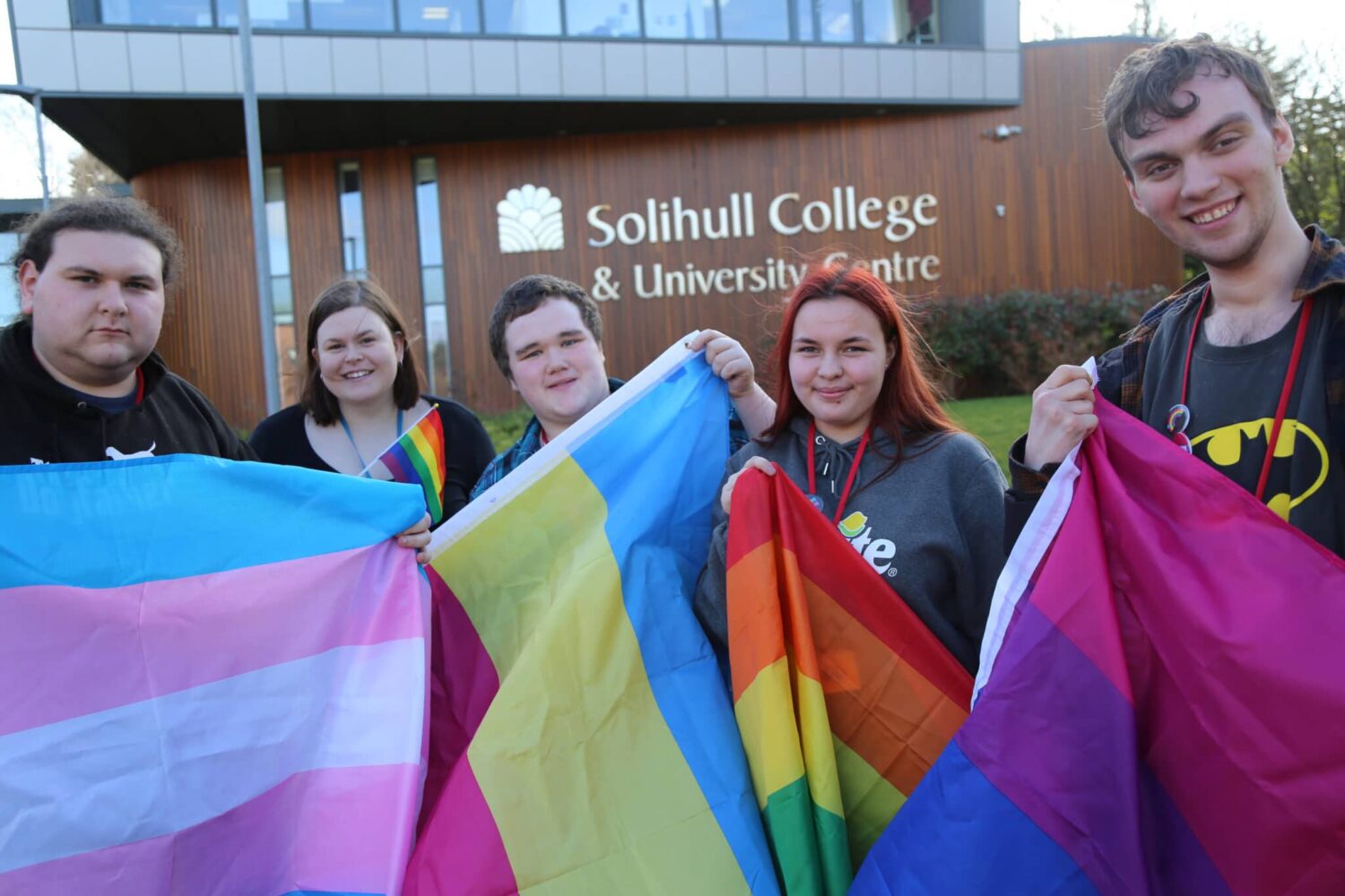 Students from the college including Will Pullen in the centre hold a flags for LGBT+ history month.