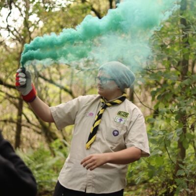 Aaron with green smoke in forest