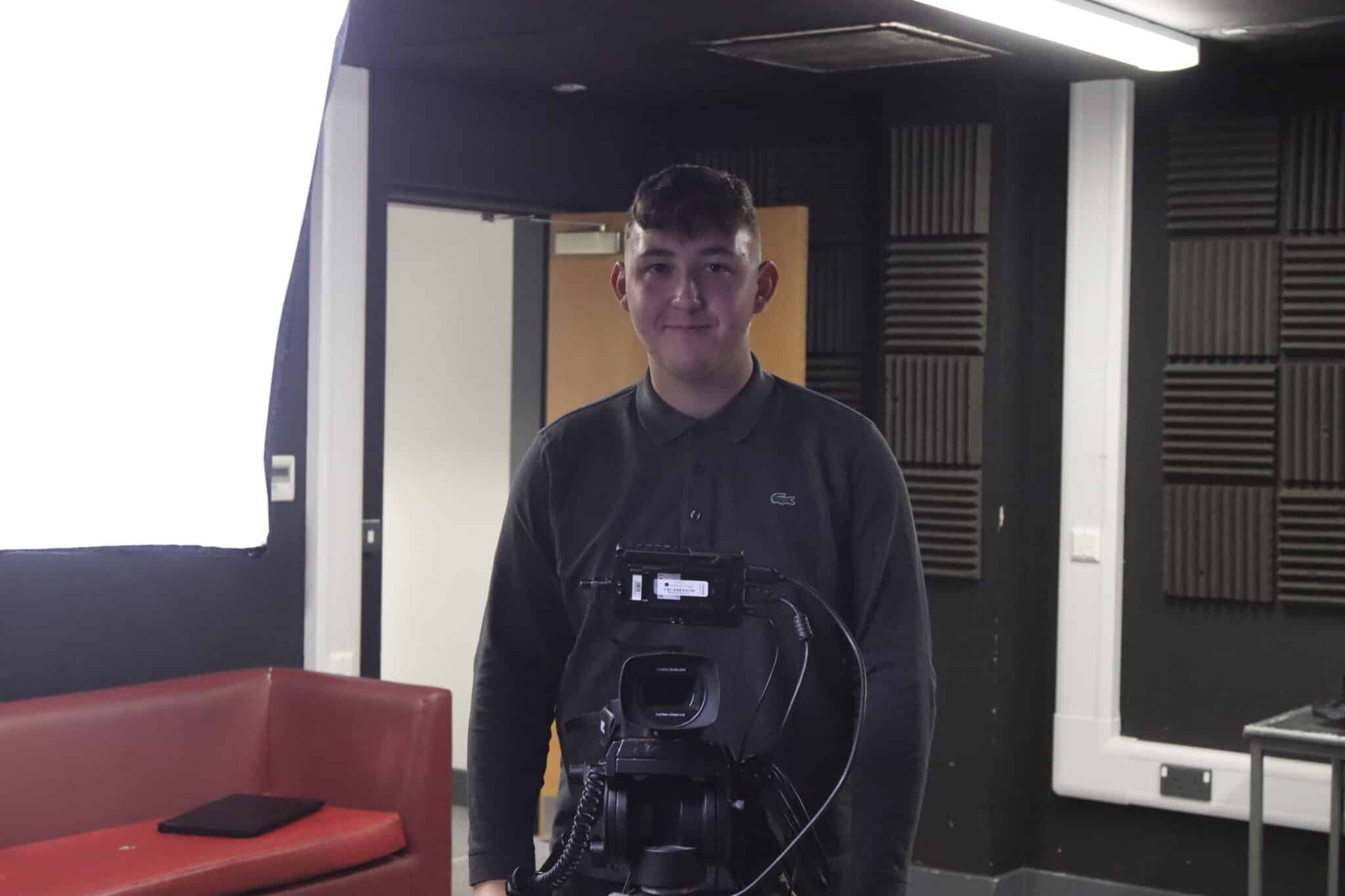 Student looking at camera in college tv studio