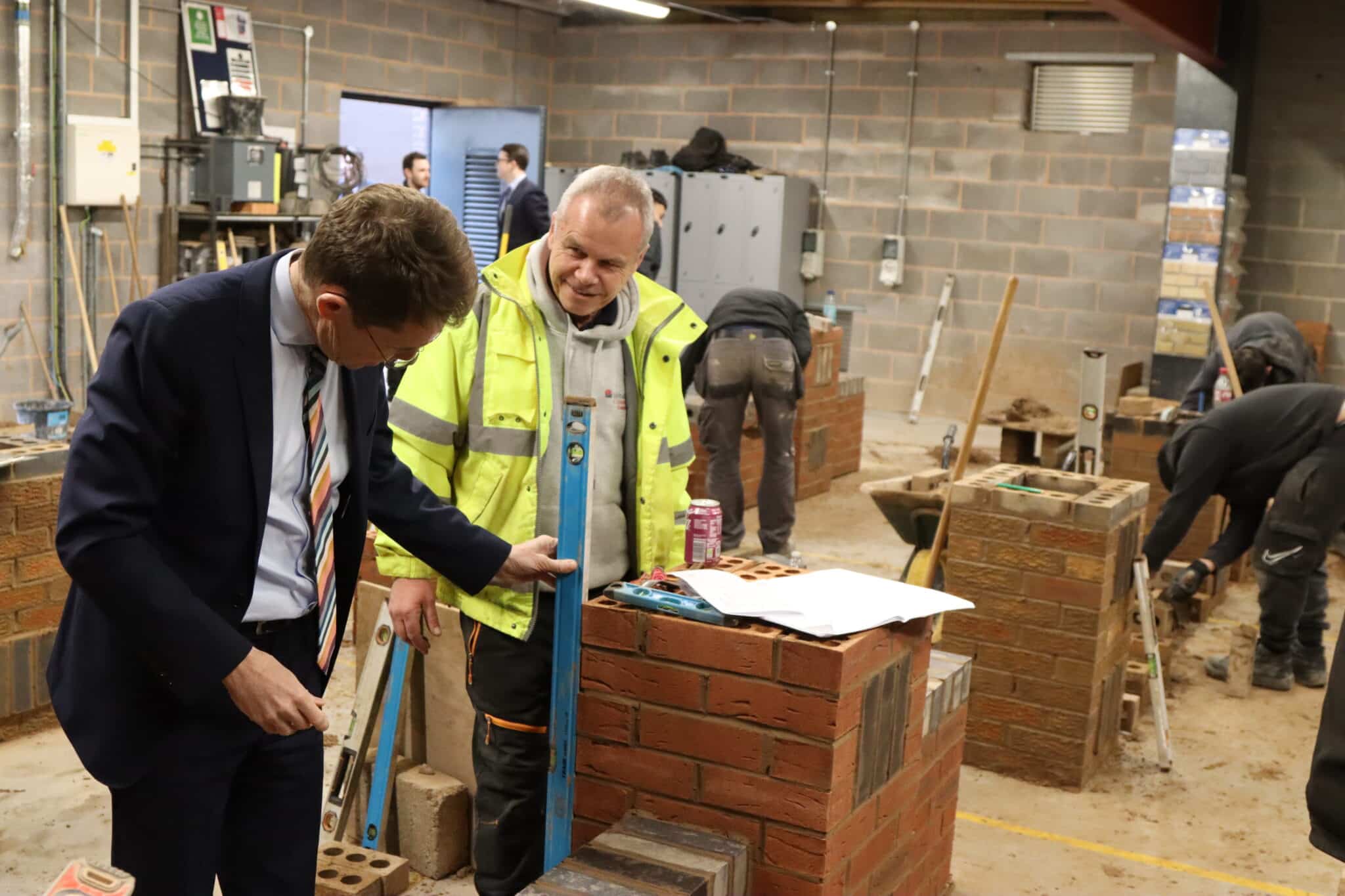 Bricklaying being demonstrated for Mayor Andy Street