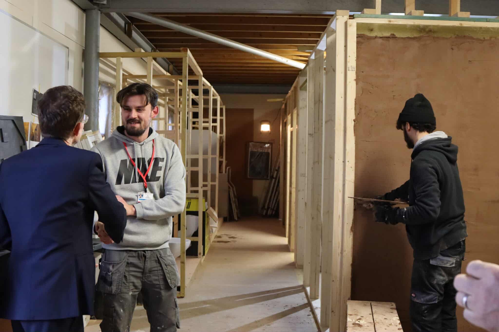 Andy Street chaking hands with student(s) doing carpentry