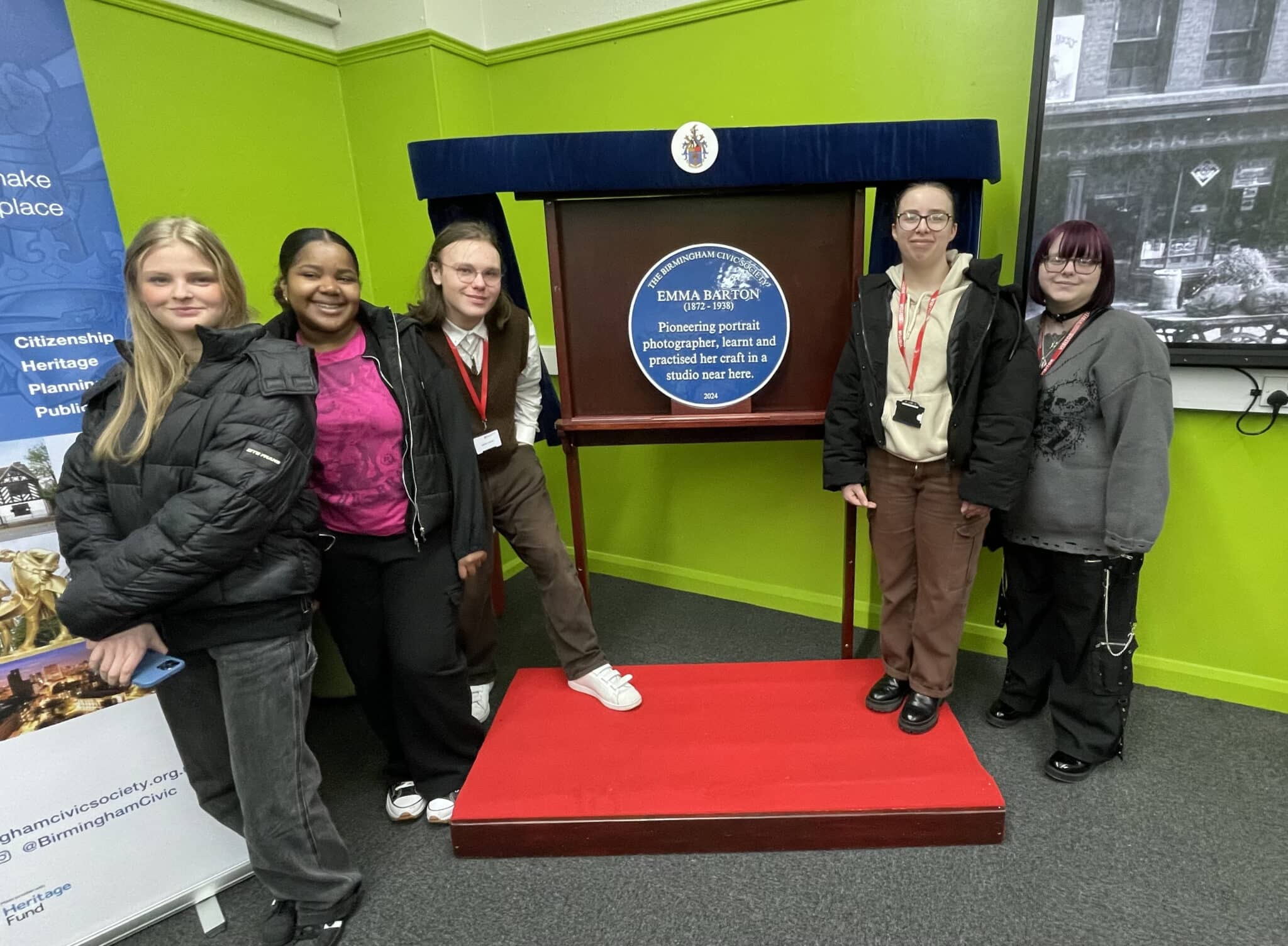 5 students stood next to blue plaque Emma Barton