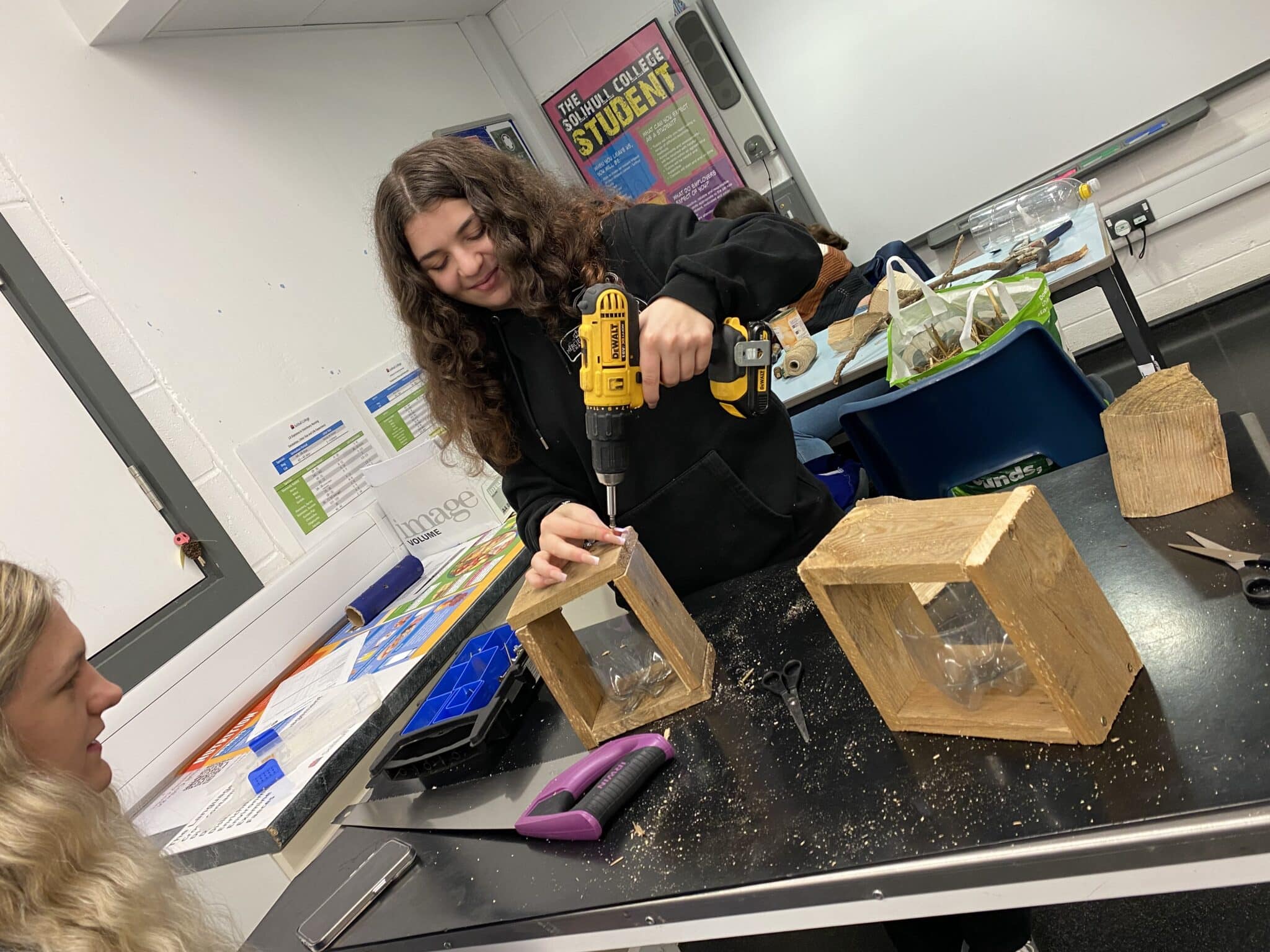 student making a nest box for hedgehog