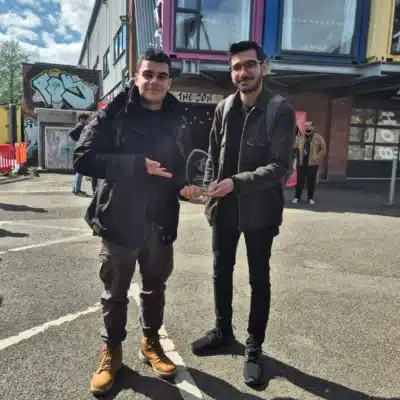 sam and juan hold award after receiving it at the festival