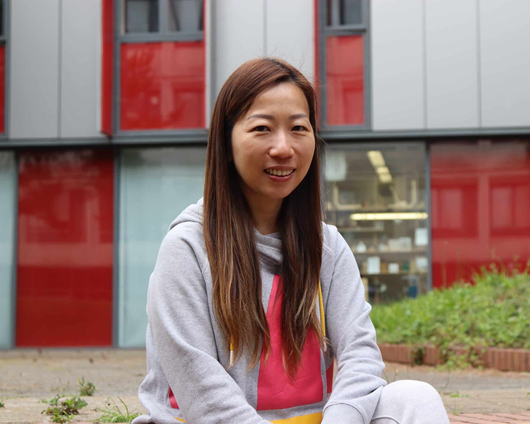 Mum thrives thanks to College's adult courses - Kitty sat on the steps in front of college building