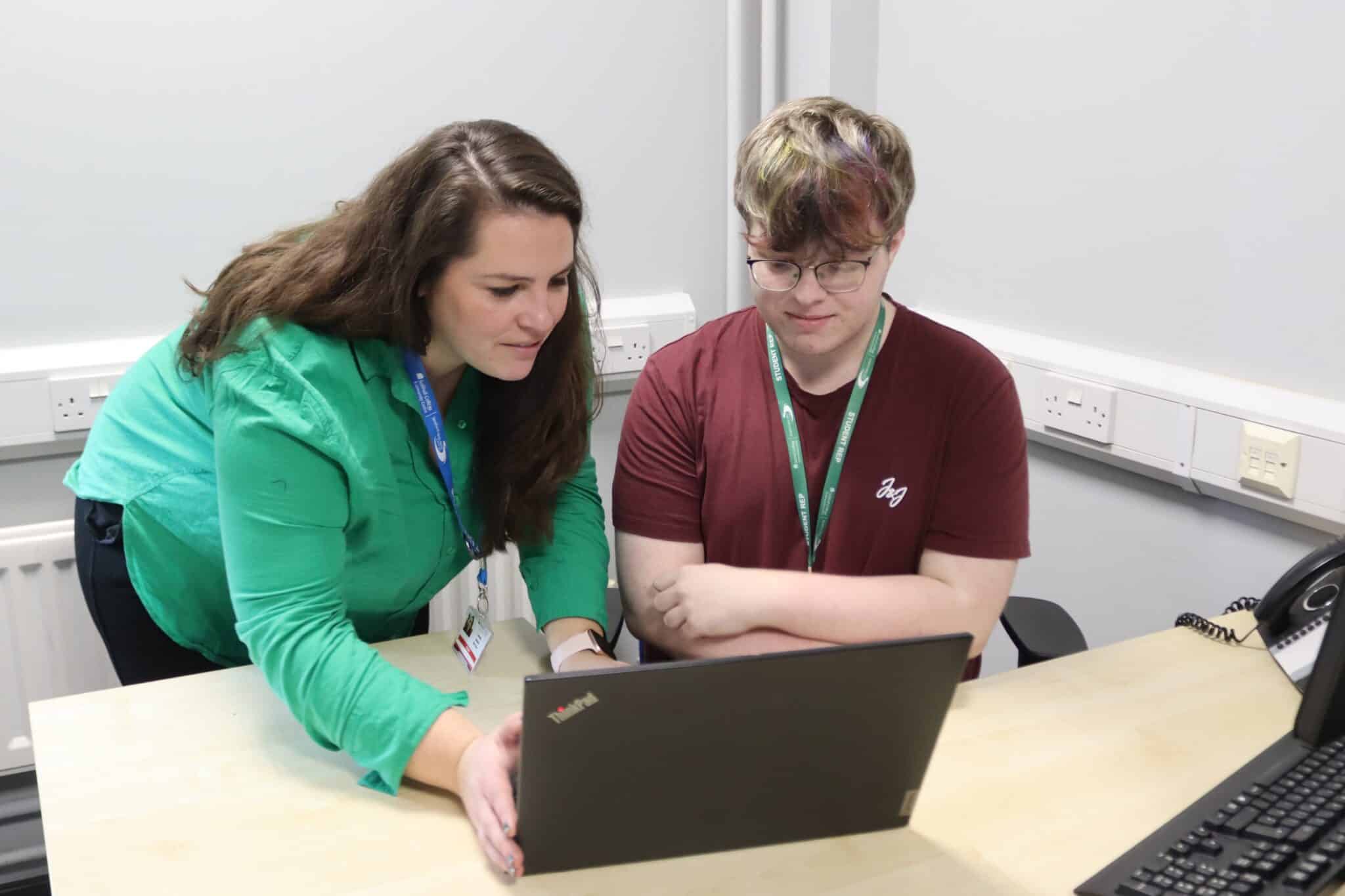 GSCE English student ray, wins National writing competition - Rachel and Ray looking at the laptop