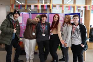 a group of students and staff standing and smiling