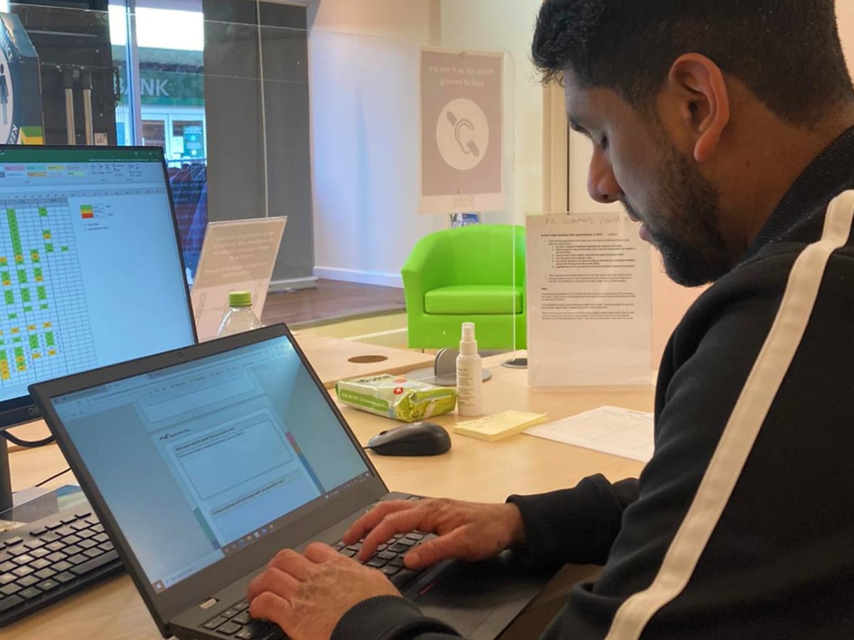 Solihull College learner on a Supported Internship sitting at a laptop.