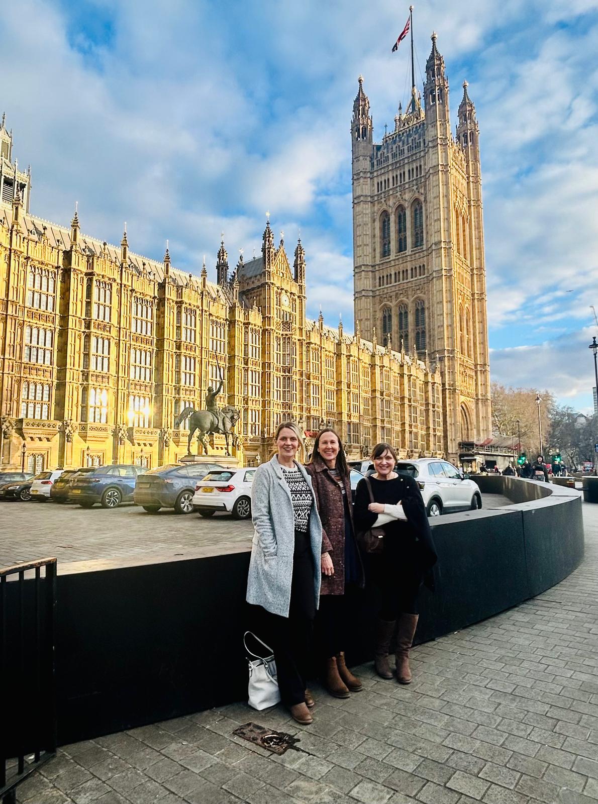 The team standing outside Houses of Parliament